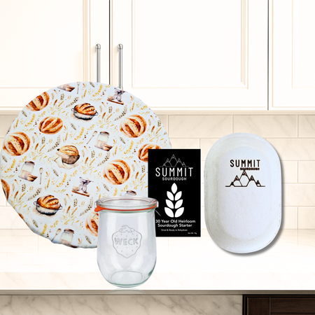 Sourdough bread themed 4 piece bakers kit includes reusable bowl cover, banneton brotform, heirloom sourdough starter and weck jar.