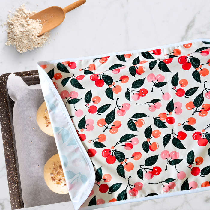 Reusable XL proofing cover with red cherry print on a white background, perfect for sourdough bakers and summer baking.
