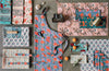 Danica Heirloom Poppy hand block print cotton apron displayed with coordinating kitchen linens and textiles.