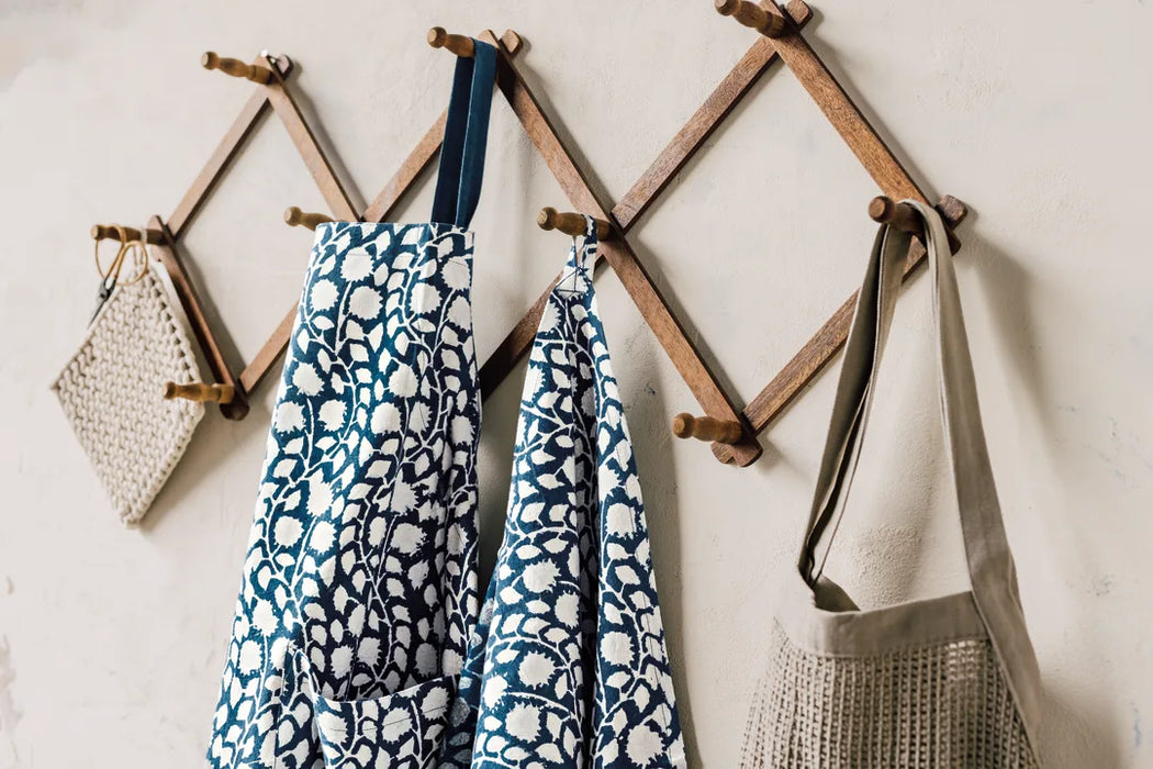 Danica Heirloom Vinebloom hand block print cotton baking apron displayed with coordinating kitchen linens. Sourdough baking apron.