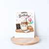 Whimsical sourdough birthday greeting card displayed in a cozy lifestyle mockup with a kraft envelope, flowers, and a coffee mug.