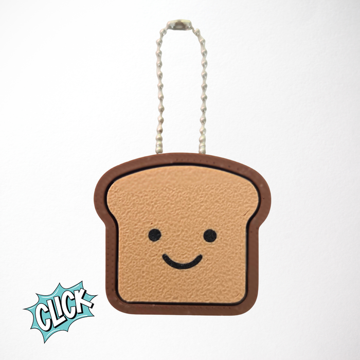 3D-printed sourdough loaf clicker keychain in a bread shape, shown in warm toasty color, used as a stress relief ASMR fidget toy.