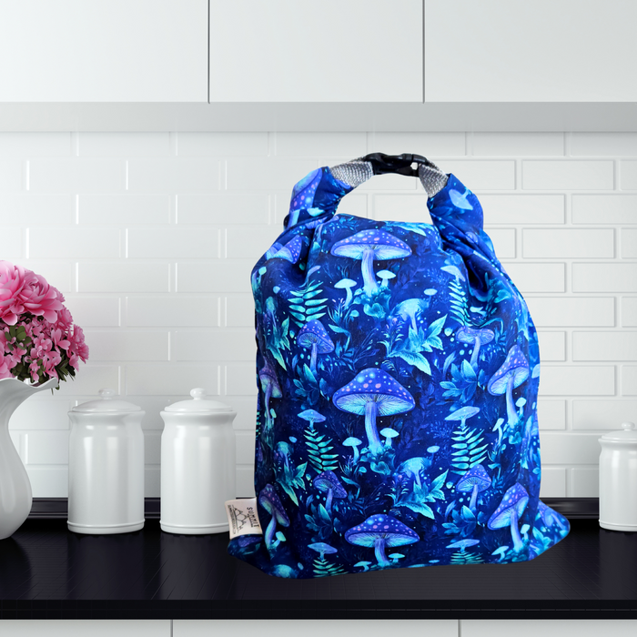 Reusable bread storage bag with purple and blue mushroom print—fairy-tale inspired, perfect for sourdough bakers.