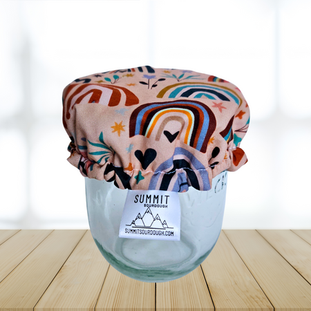 Pink rainbow fabric cover on a sourdough starter jar