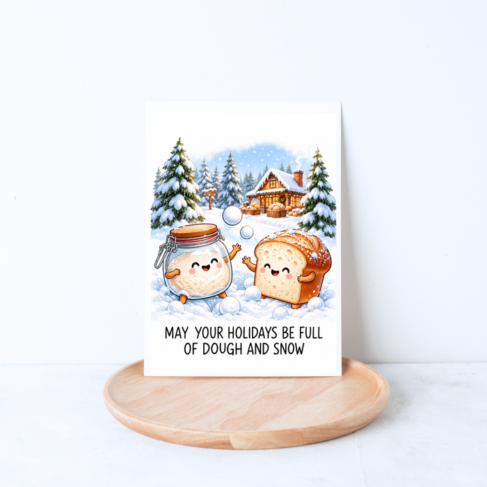 May your holidays be full of dough and snow sourdough Christmas card featuring a bread loaf and sourdough starter having a snowball fight