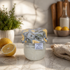 Reusable sourdough jar cover with lemon print on a glass starter jar in a bright kitchen