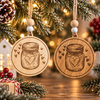 Two laser-engraved wooden sourdough starter jar Christmas ornaments in light and dark wood, featuring a mason jar with a heart, hanging from festive evergreen branches.